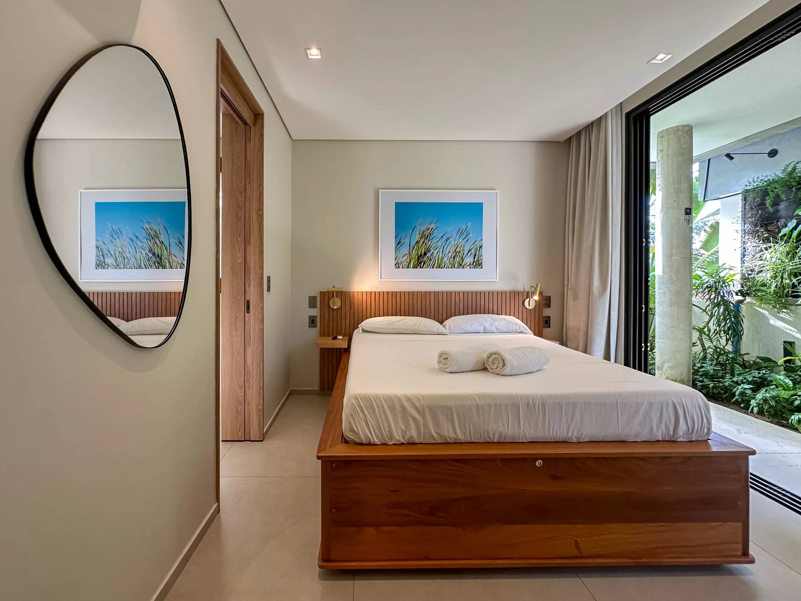 Bedroom at Vila Manga Rosa with warm natural materials